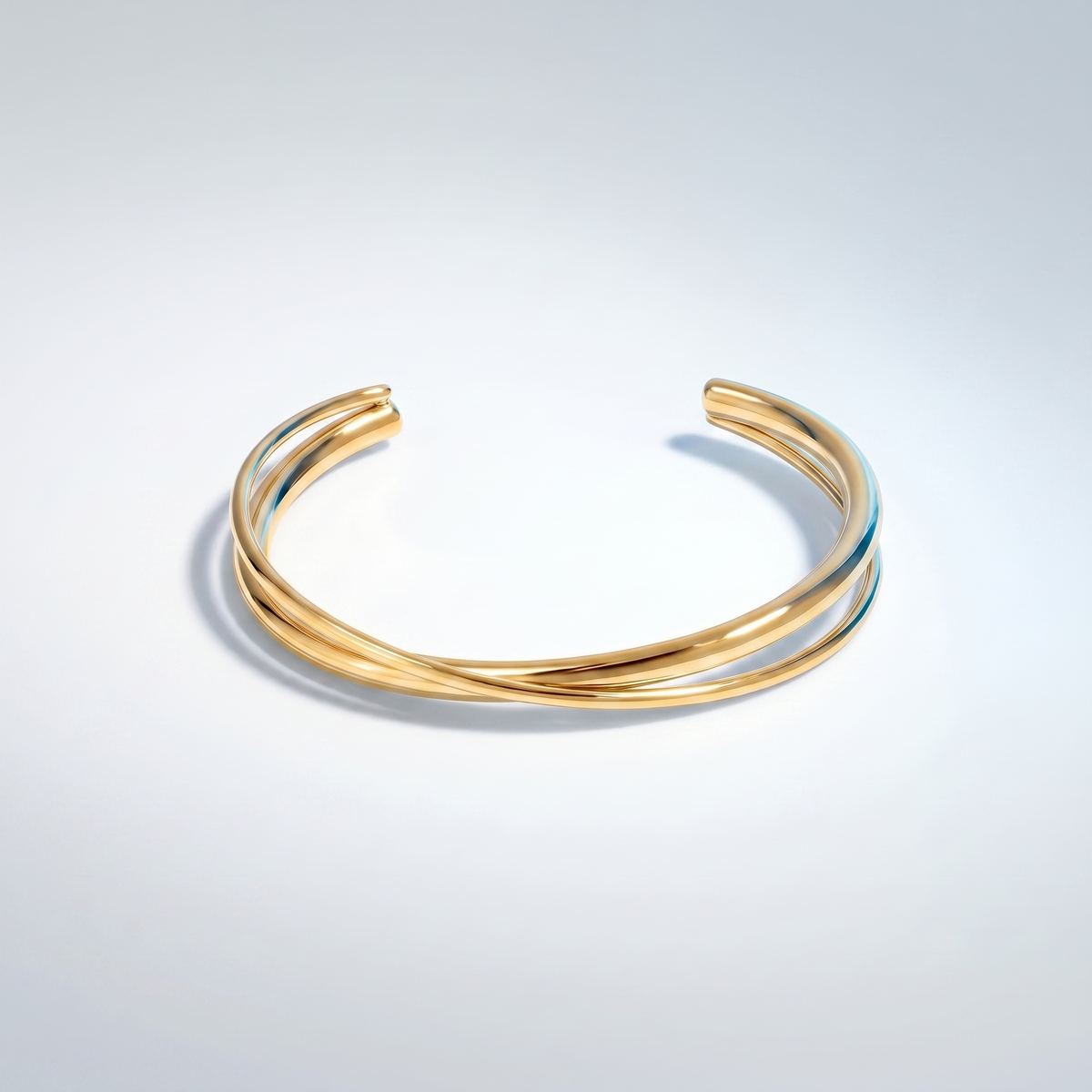 Brazalete rígido cruzado bañado en oro de 18K visto desde arriba