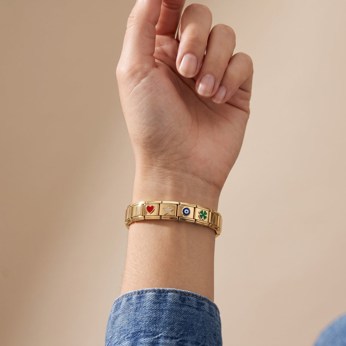 Pulsera modular con charms bañada en oro de 18K puesta, primer plano