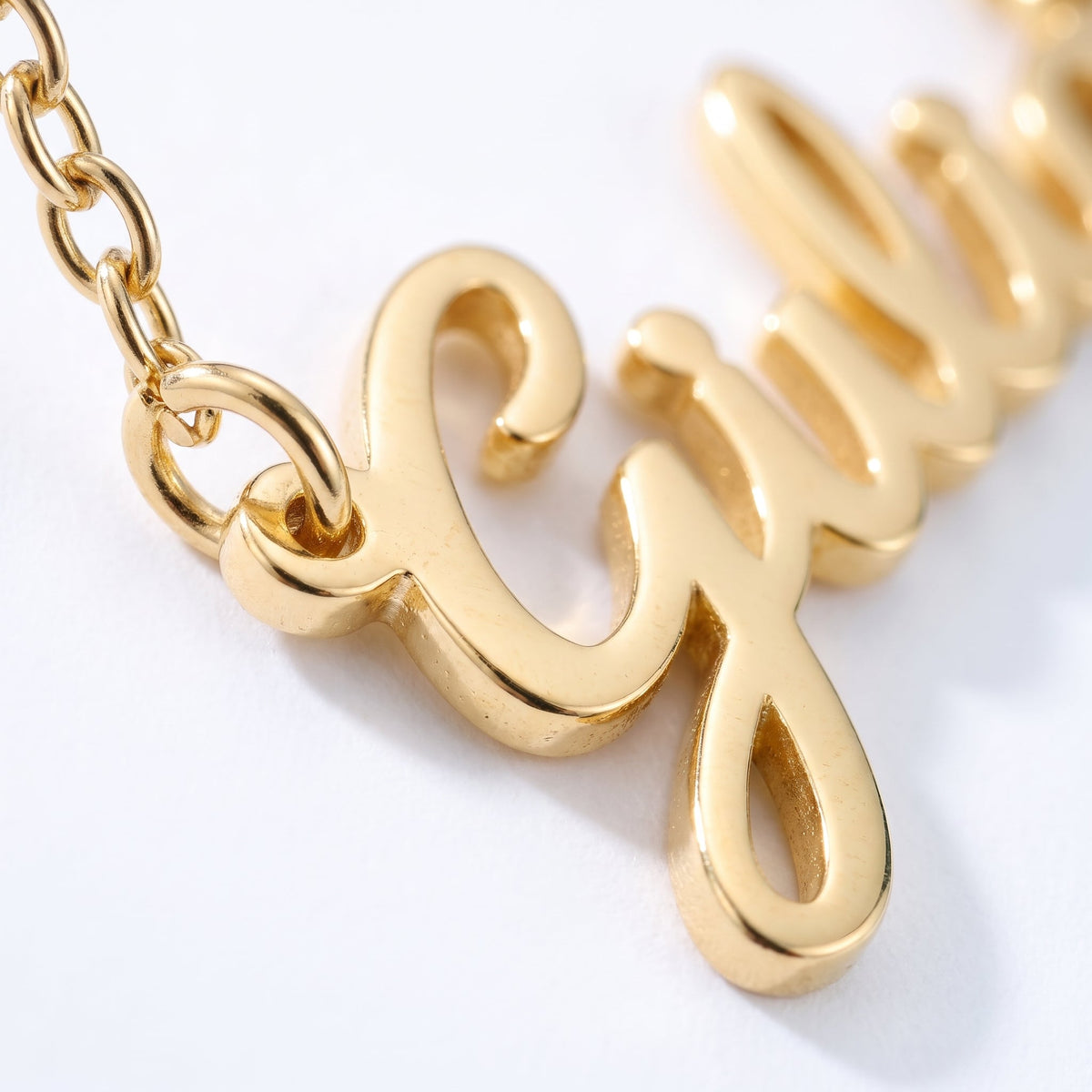 Collar con nombre en cursiva bañado en oro de 18K, detalle de cerca