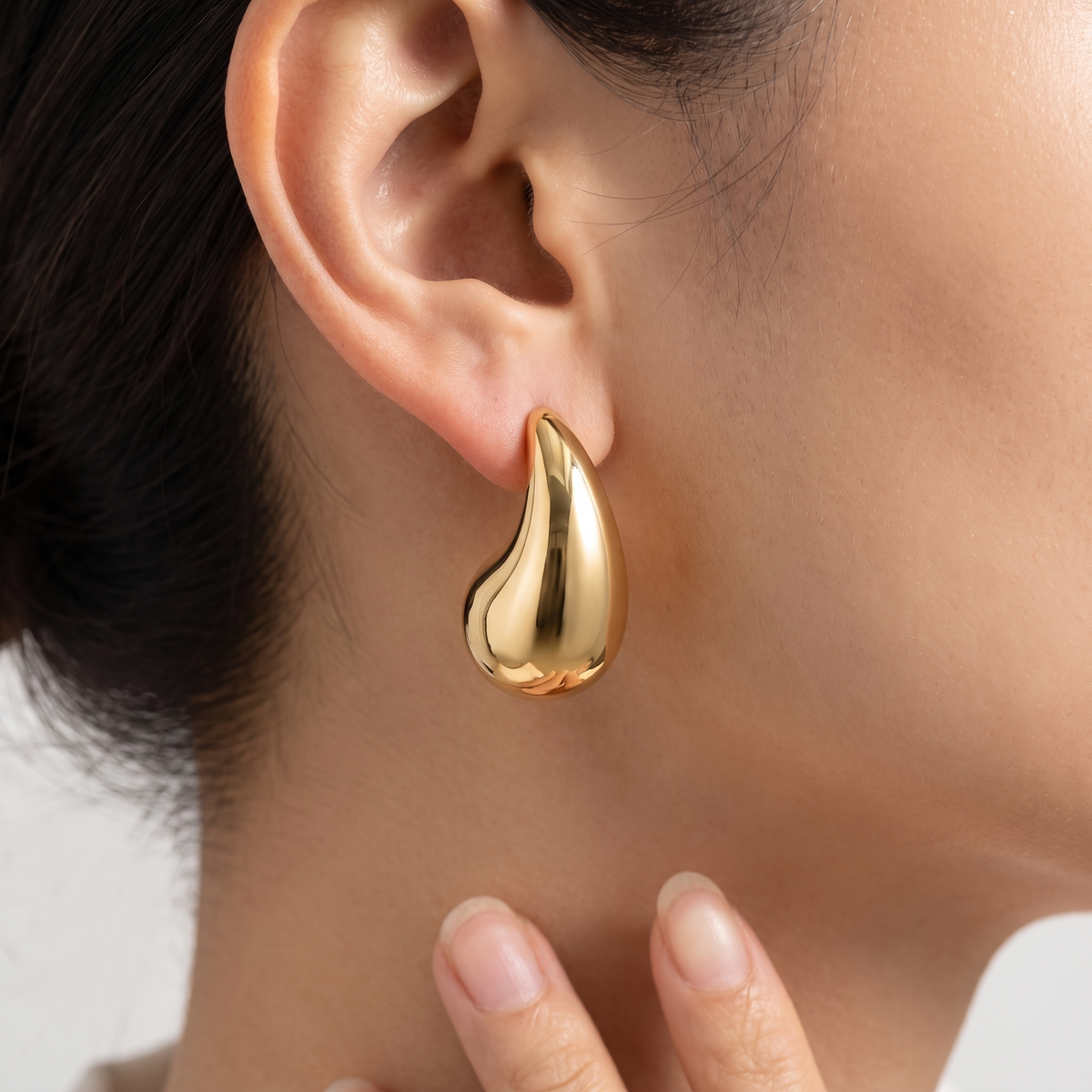 Orecchini goccia bombata leggeri placcati oro 18K indossati, primo piano