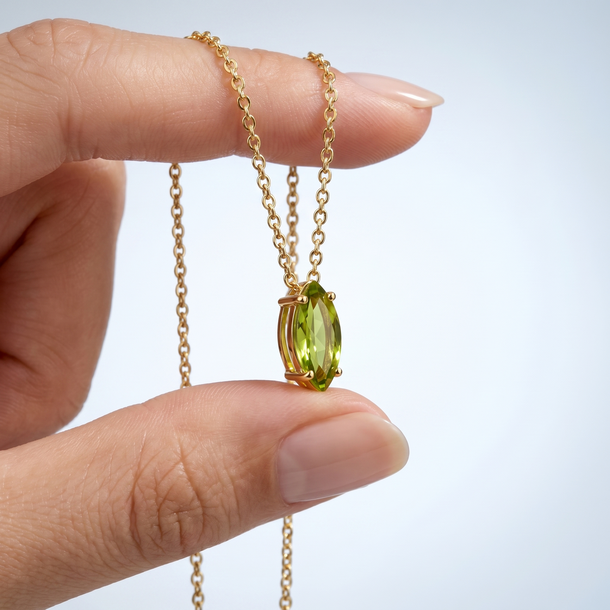 Collana peridoto baguette placcata oro 18K tenuta tra le dita, per vedere le dimensioni reali