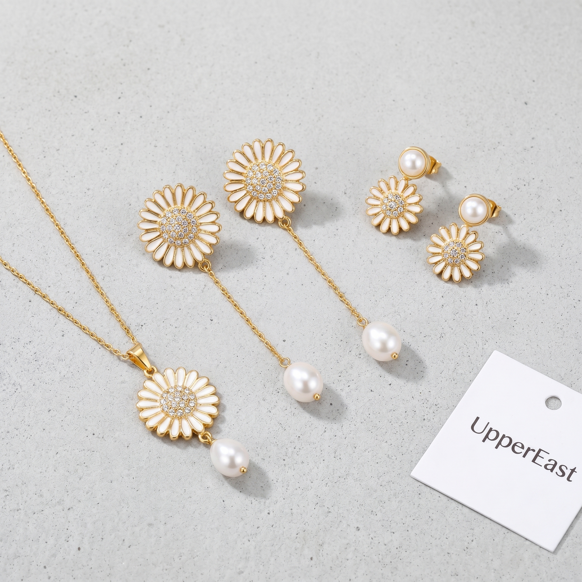 Pendientes colgantes de sol y perla bañados en oro de 18K combinados con otras joyas UpperEast